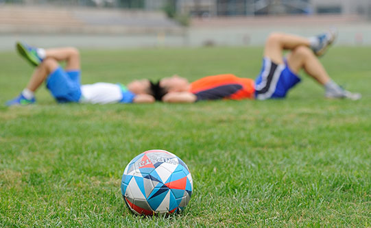 Soccer ball with children in back ground
